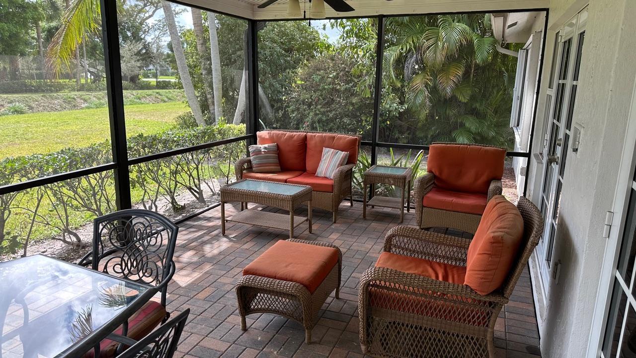 6594 Casabella Lane Boca Raton, FL 33433 - Photo 5 of 28 a balcony with wooden floor and outdoor seating