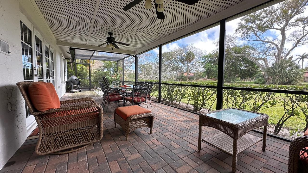 6594 Casabella Lane Boca Raton, FL 33433 - Photo 7 of 28 a balcony with wooden benches and wooden floor