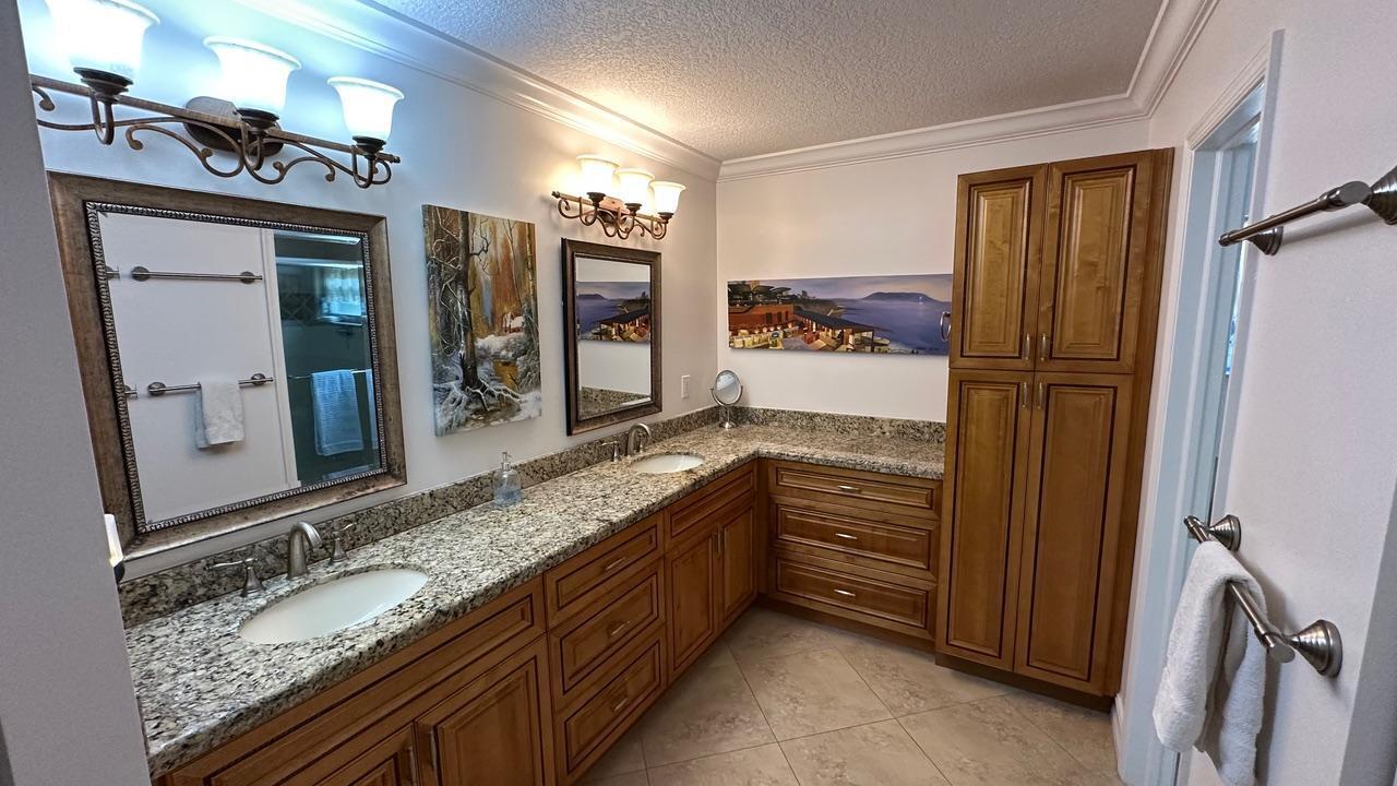 6594 Casabella Lane Boca Raton, FL 33433 - Photo 10 of 28 a bathroom with a granite countertop double vanity sink and mirror