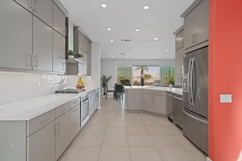 a kitchen with a sink refrigerator and cabinets
