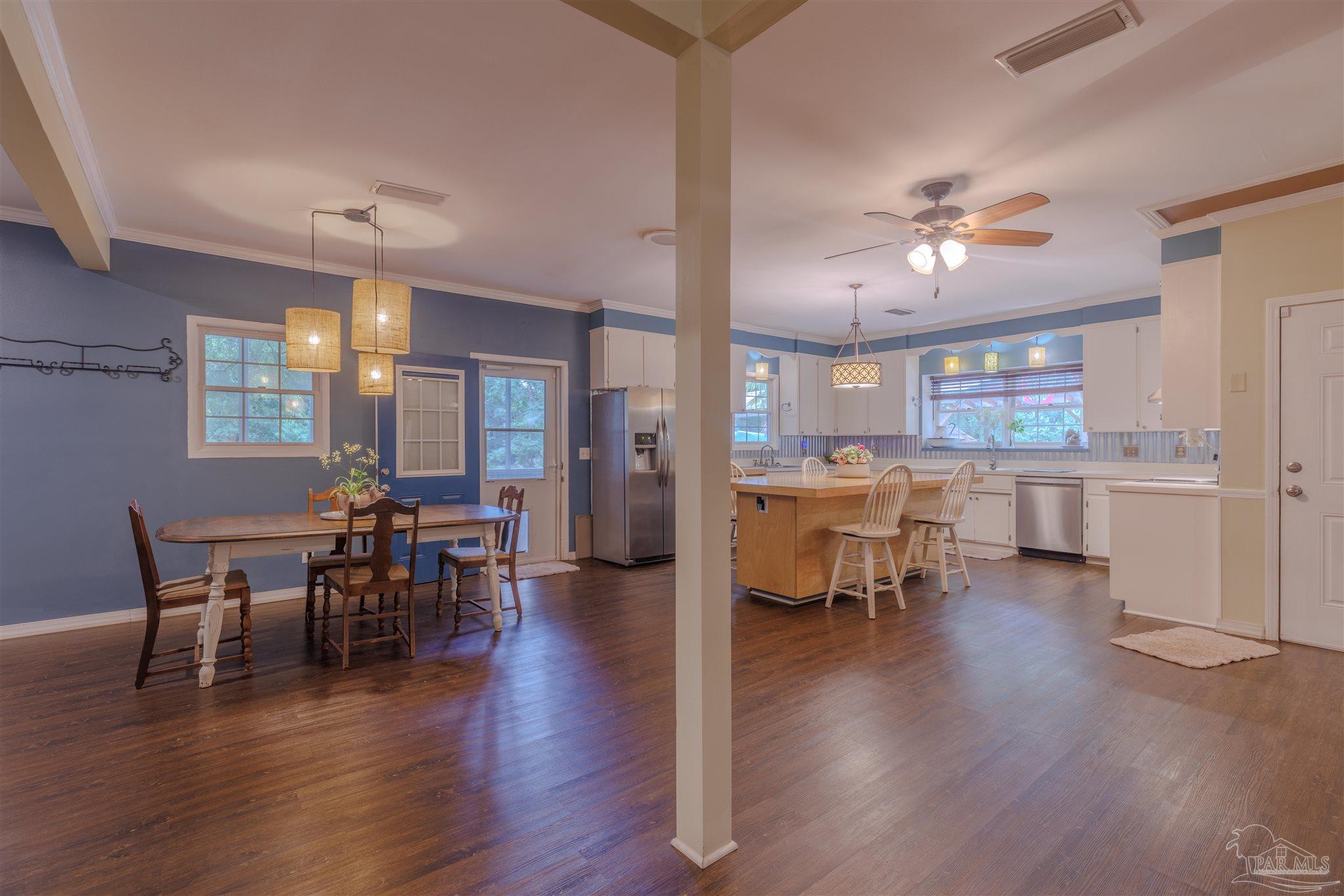 5049 Guernsey Road Pace, FL 32571 - Photo 20 of 61 a view of a dining room with furniture window and wooden floor