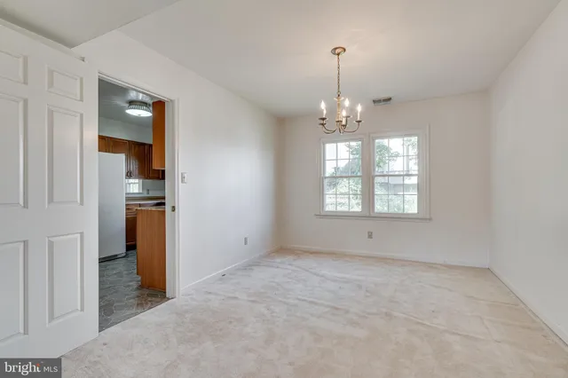 an empty room with windows and entrance