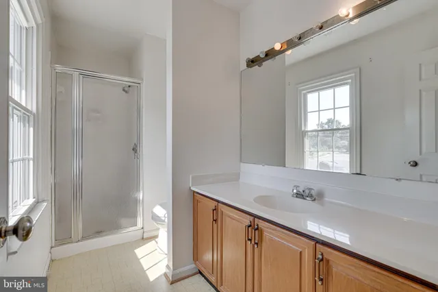a bathroom with a sink mirror and a bathtub