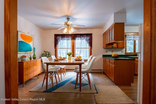 a view of a dining room with furniture window and wooden floor