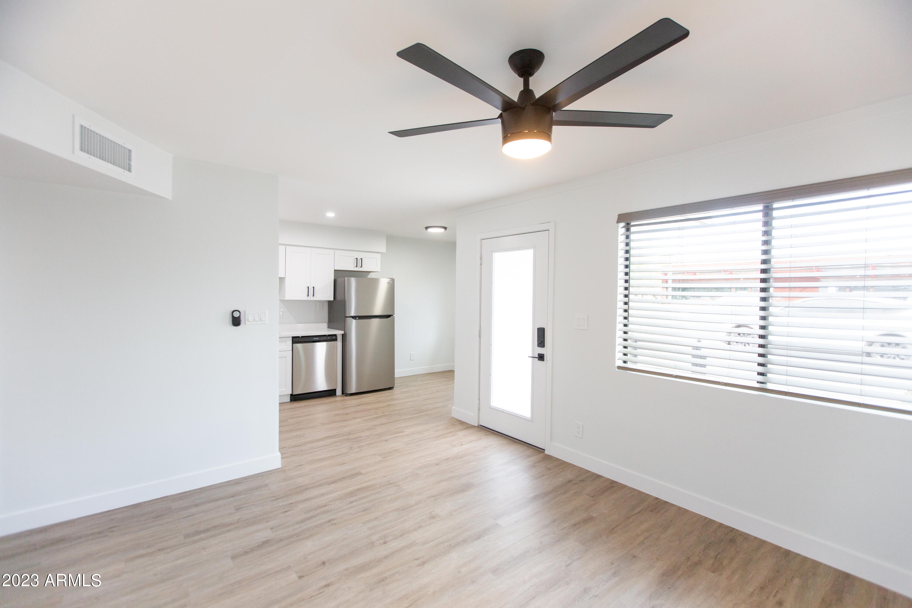 3133 East Fairmount Avenue Phoenix, AZ 85016 - Photo 4 of 11 a view of a big room with wooden floor and windows