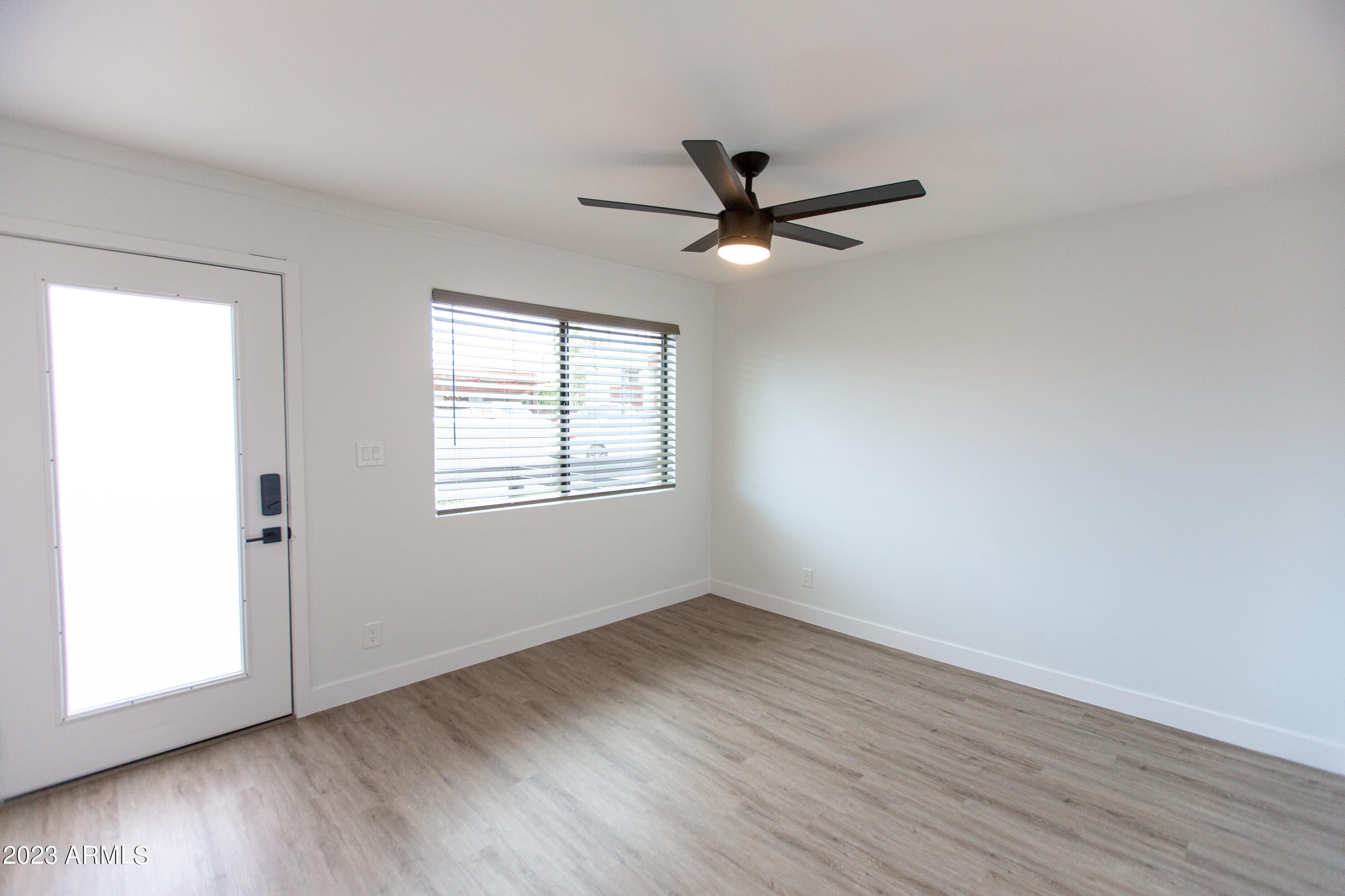 3133 East Fairmount Avenue Phoenix, AZ 85016 - Photo 6 of 11 a view of empty room with wooden floor and fan