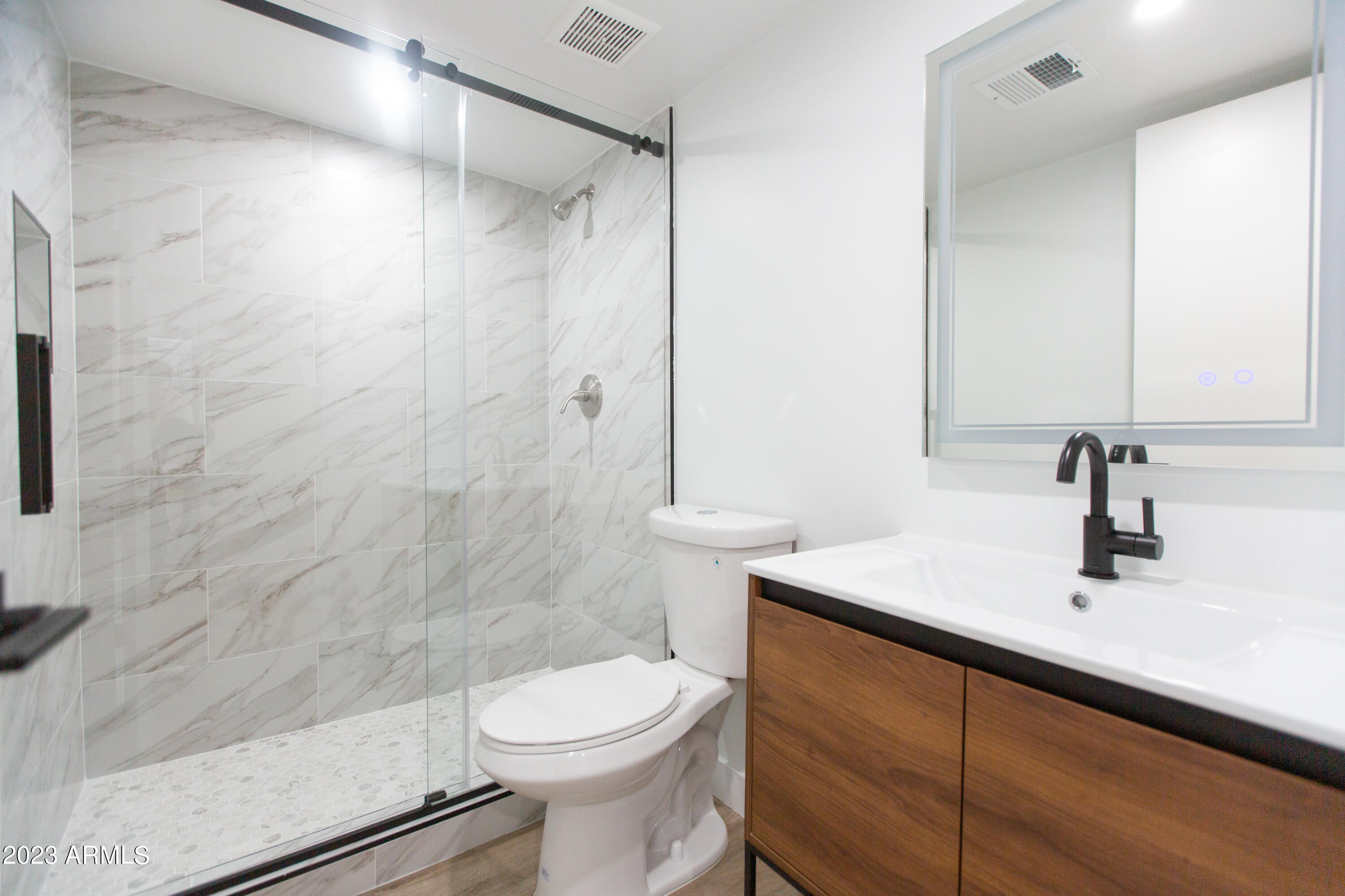 3133 East Fairmount Avenue Phoenix, AZ 85016 - Photo 7 of 11 a bathroom with a sink a toilet and shower