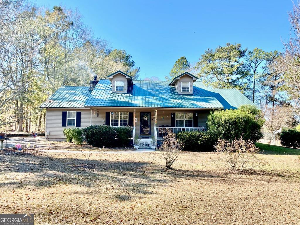 2336 Cedar Creek Church Road Collins, GA 30421 - Photo 1 of 1 a front view of a house with a yard covered with snow in front of house