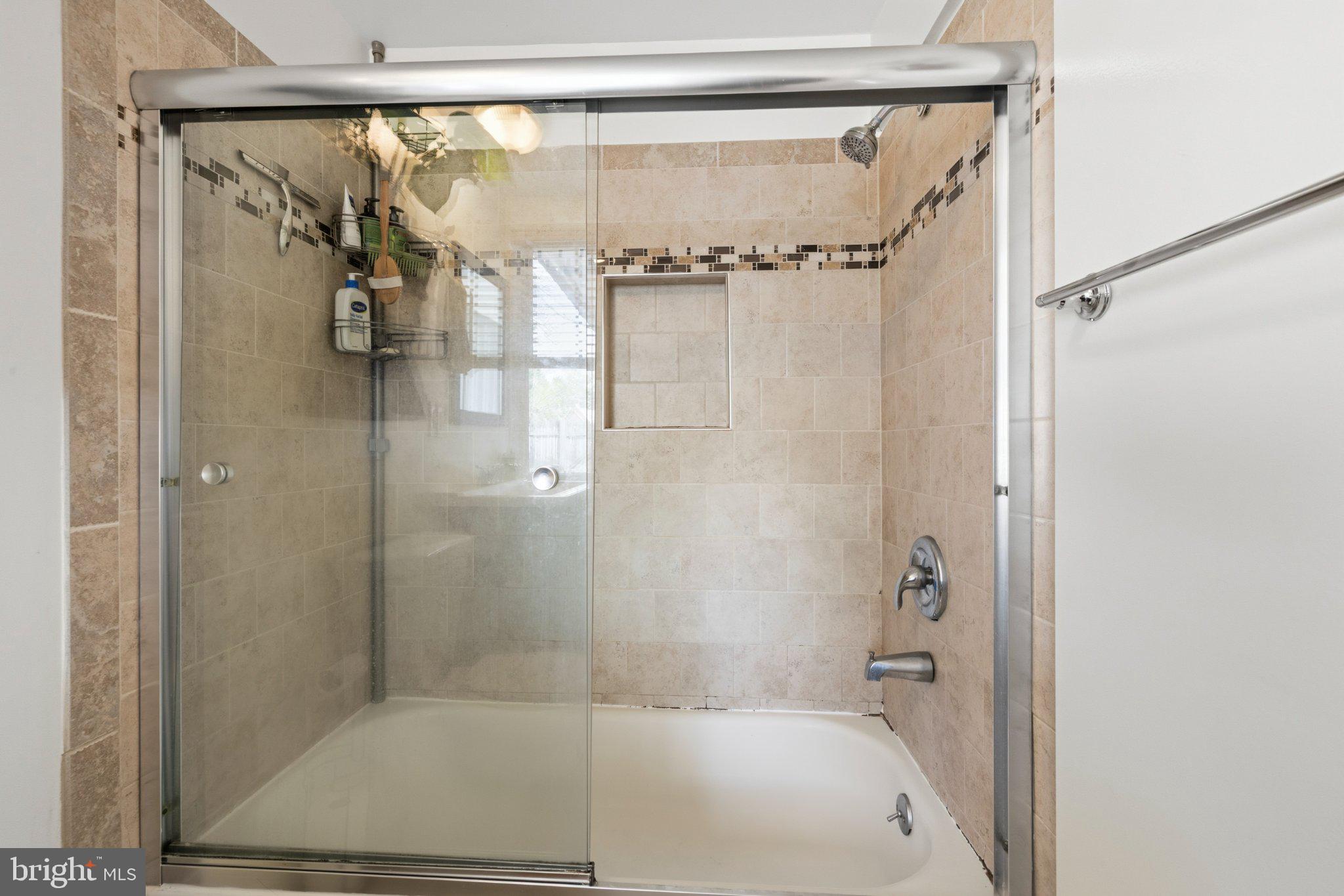 465 West South Street Frederick, MD 21701 - Photo 13 of 34 a bathroom with a glass shower door