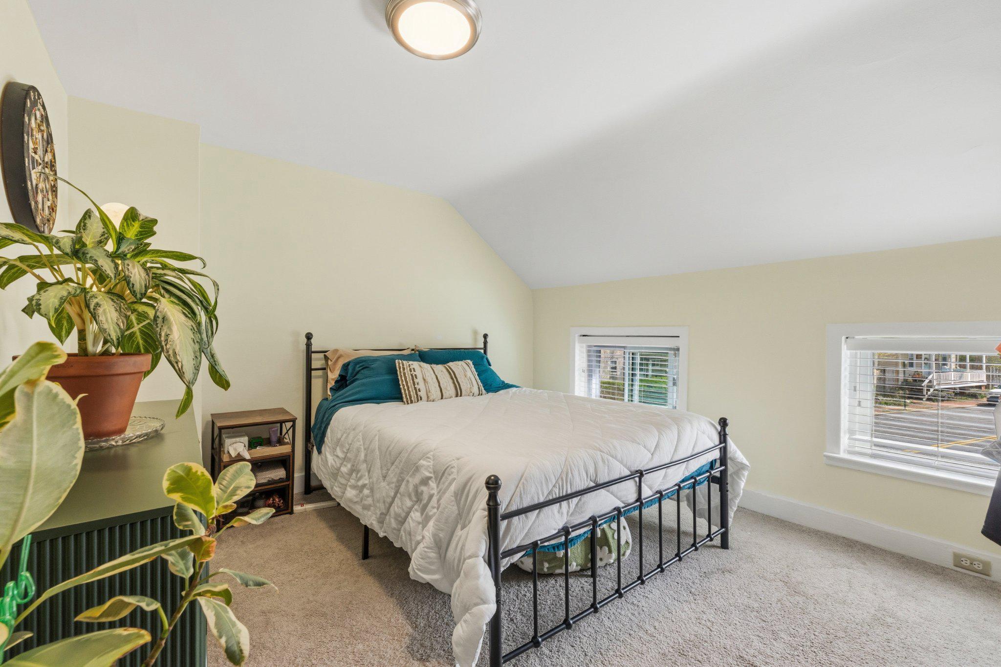 465 West South Street Frederick, MD 21701 - Photo 18 of 34 a bedroom with a bed lamp and a potted plant