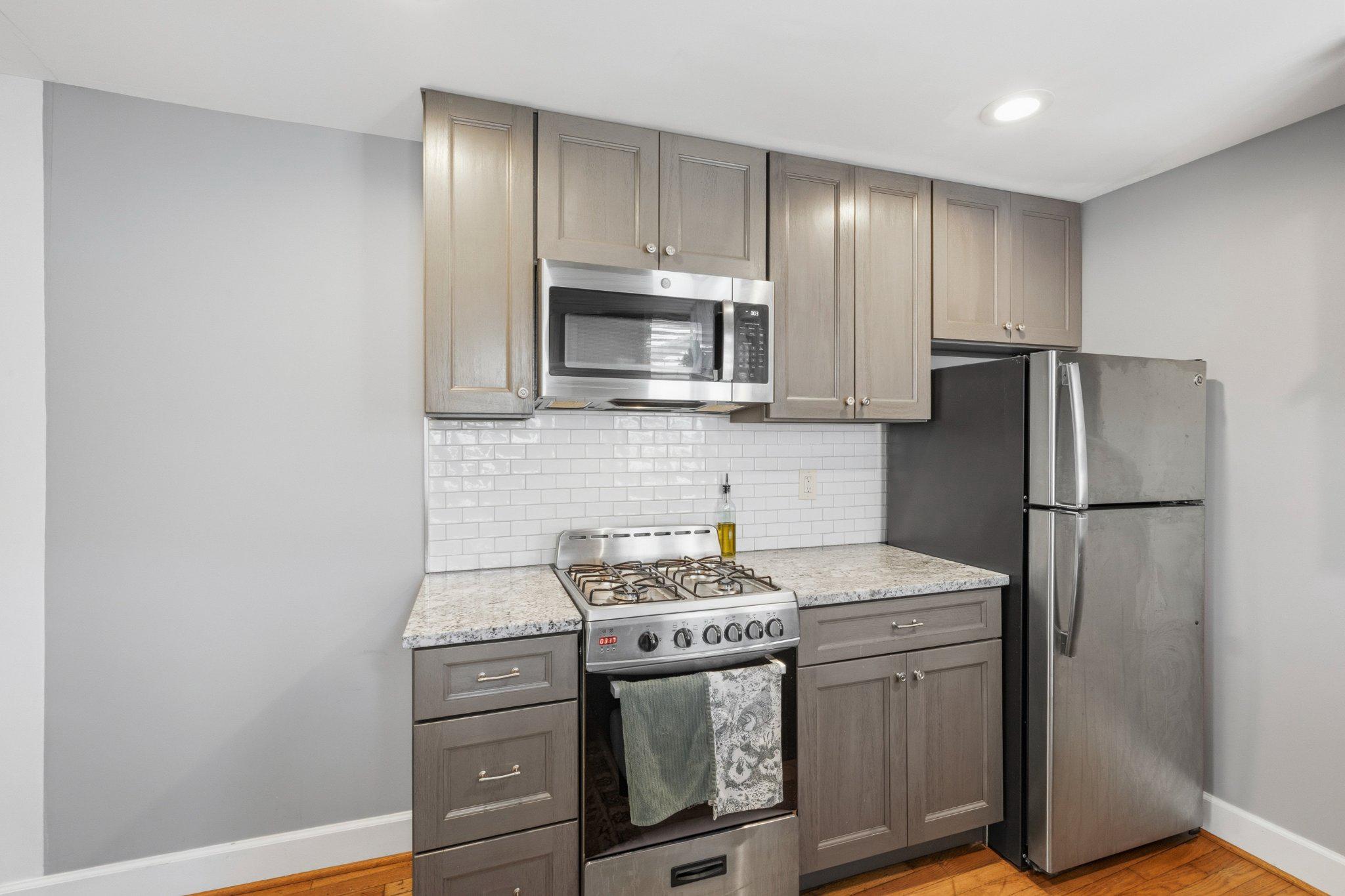465 West South Street Frederick, MD 21701 - Photo 9 of 34 a kitchen with a stove microwave and refrigerator