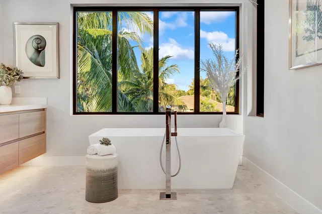 a bath tub sitting next to a window