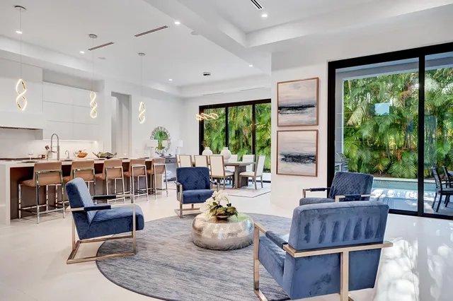 a living room with furniture and floor to ceiling windows