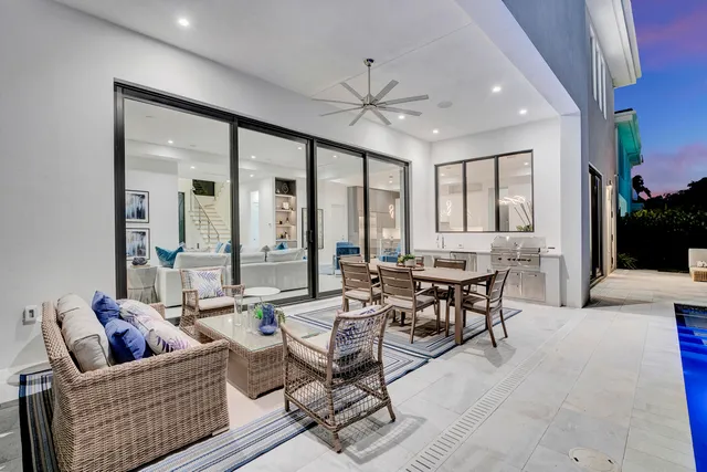 a living room with fireplace furniture and a large window