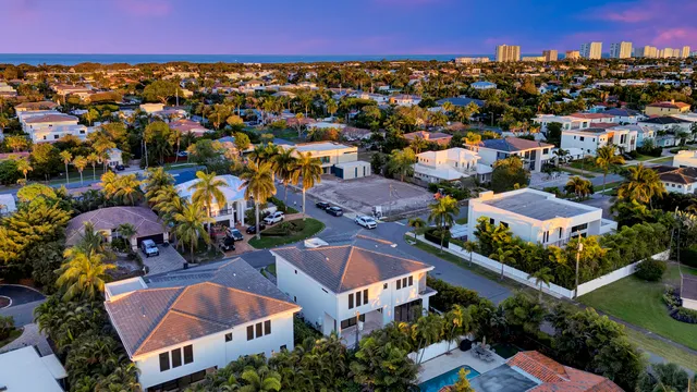 an aerial view of multiple houses with yard