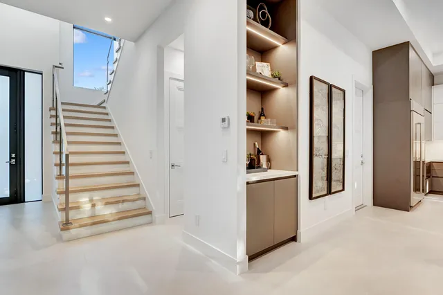 a view of a kitchen with a refrigerator and cabinets