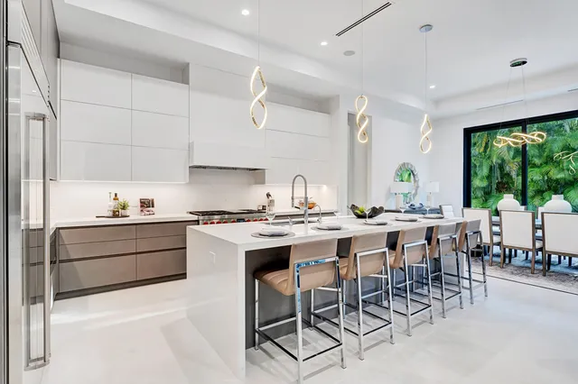 a kitchen with a sink stove and white cabinets