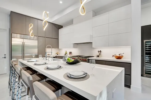a kitchen with a sink a stove and white cabinets