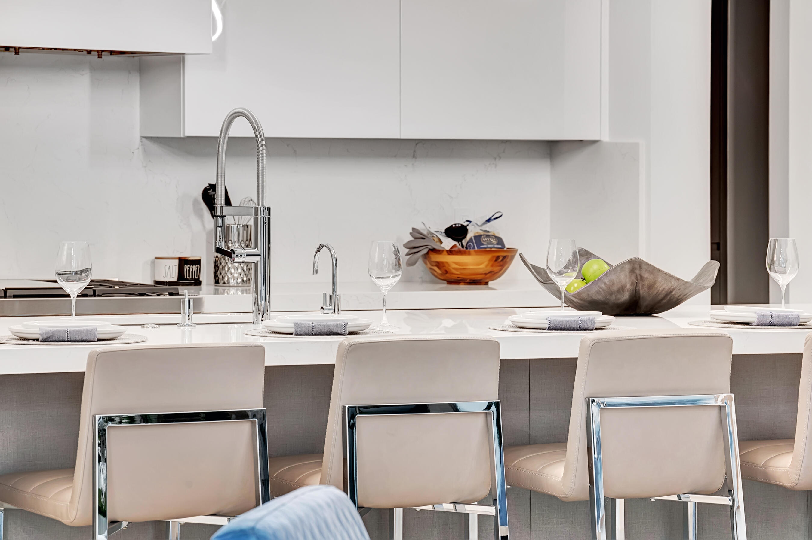 1133 Northeast 3rd Avenue Boca Raton, FL 33432 - Photo 10 of 38 a kitchen with a sink a stove and chairs with cabinets