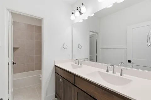 a bathroom with a sink a double vanity and a mirror