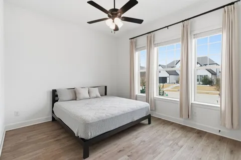 a bedroom with a large bed and a window