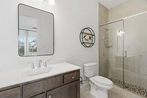 a bathroom with a toilet a sink and mirror
