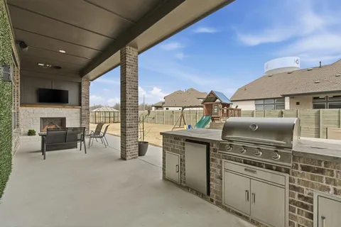 a kitchen with a stove top oven and cabinets