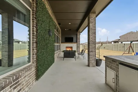 a view of a patio with table and chairs
