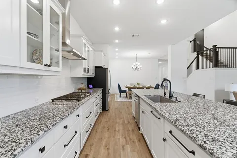 a kitchen with sink stove and cabinets