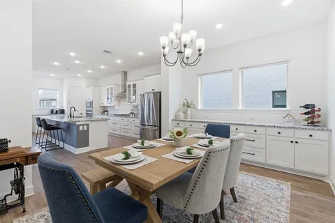 a view of a dining room and kitchen with a table chairs