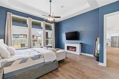 a bedroom with a bed and a flat screen tv
