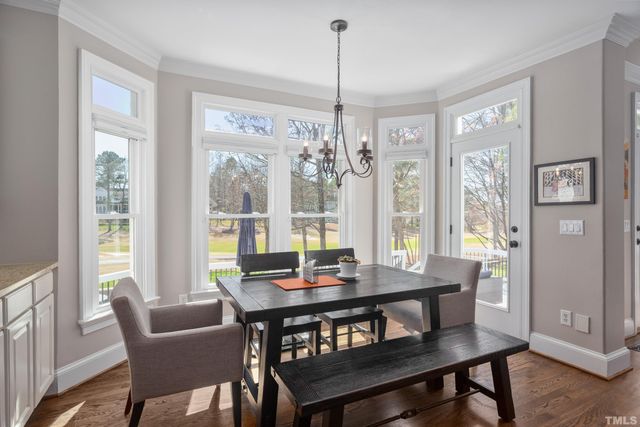 a living room with furniture large window and a fireplace