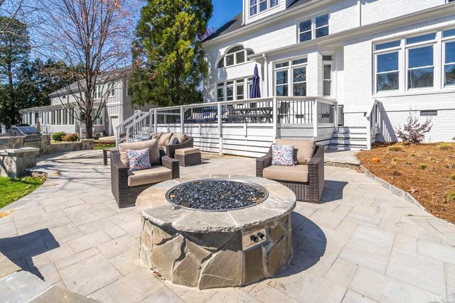 a front view of a house with garden and sitting area