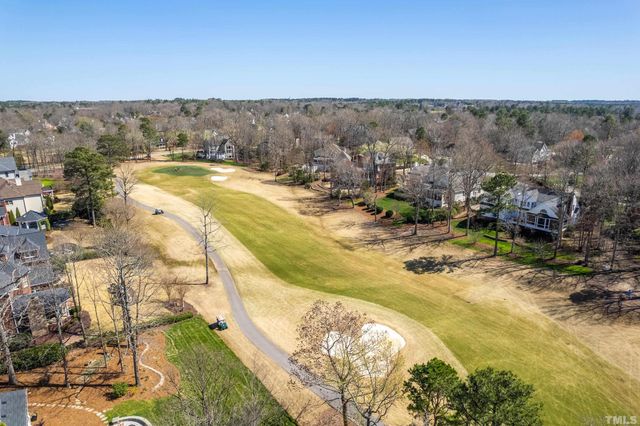an aerial view of residential houses with outdoor space and street view