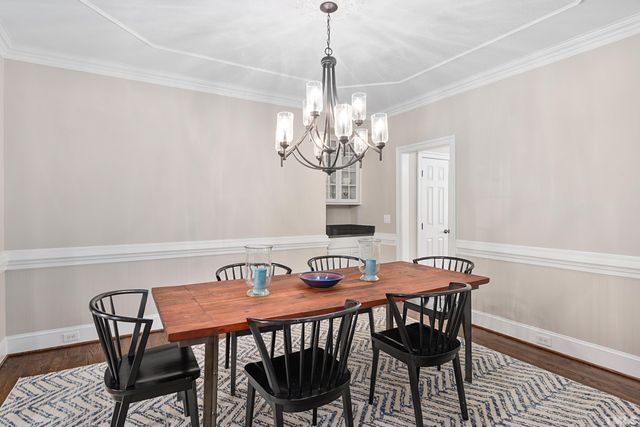 a view of a dining room with furniture and chandelier