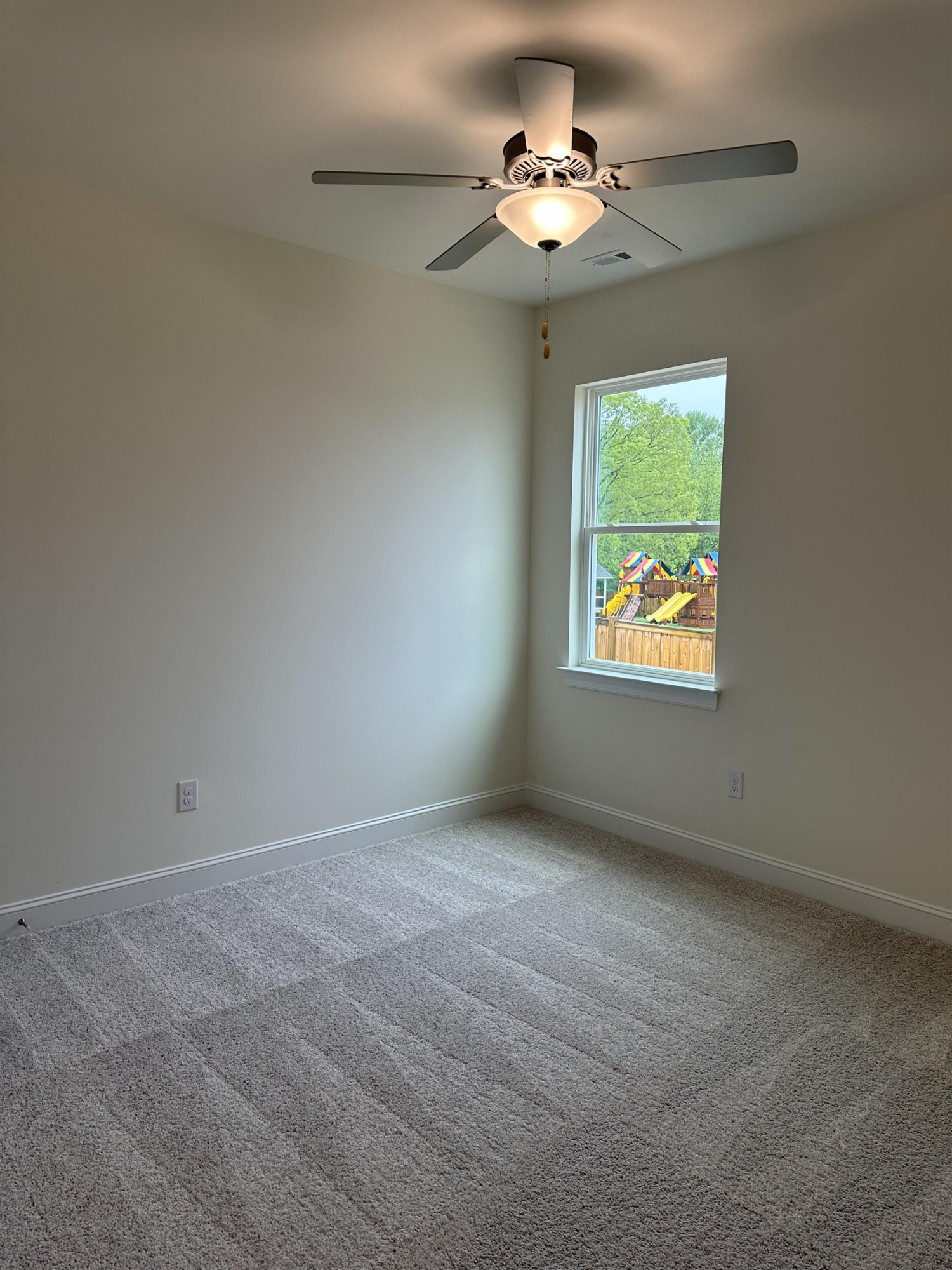4432 Beckel Road Willow Spring, NC 27592 - Photo 4 of 22 a view of an empty room with a fan