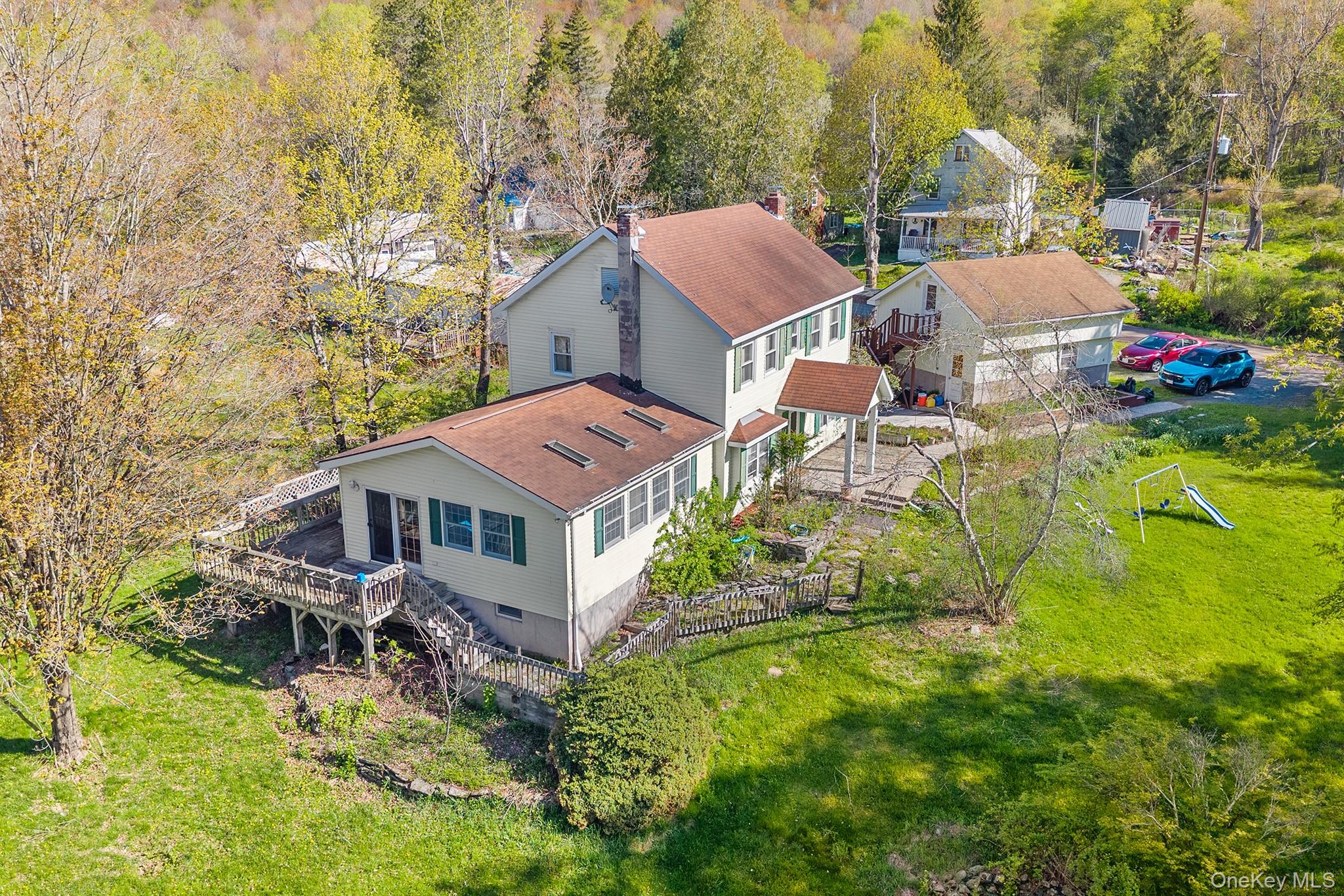 43 Taylor Road Parksville, NY 12768 - Photo 26 of 29 Expansive property featuring a multi-level residence with a large rear deck and an attached porch