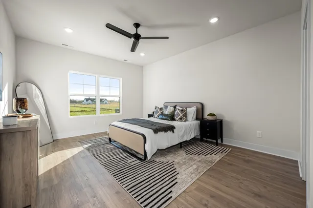 a spacious bedroom with a bed and a window