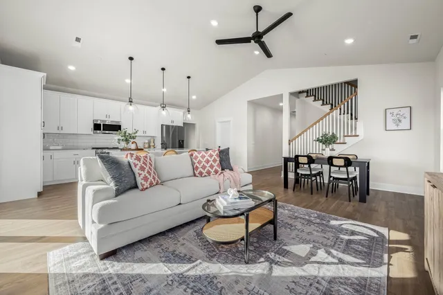 a living room with furniture and kitchen view