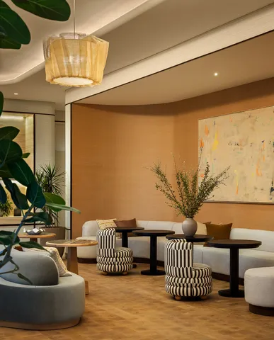 a bedroom with furniture and a potted plant