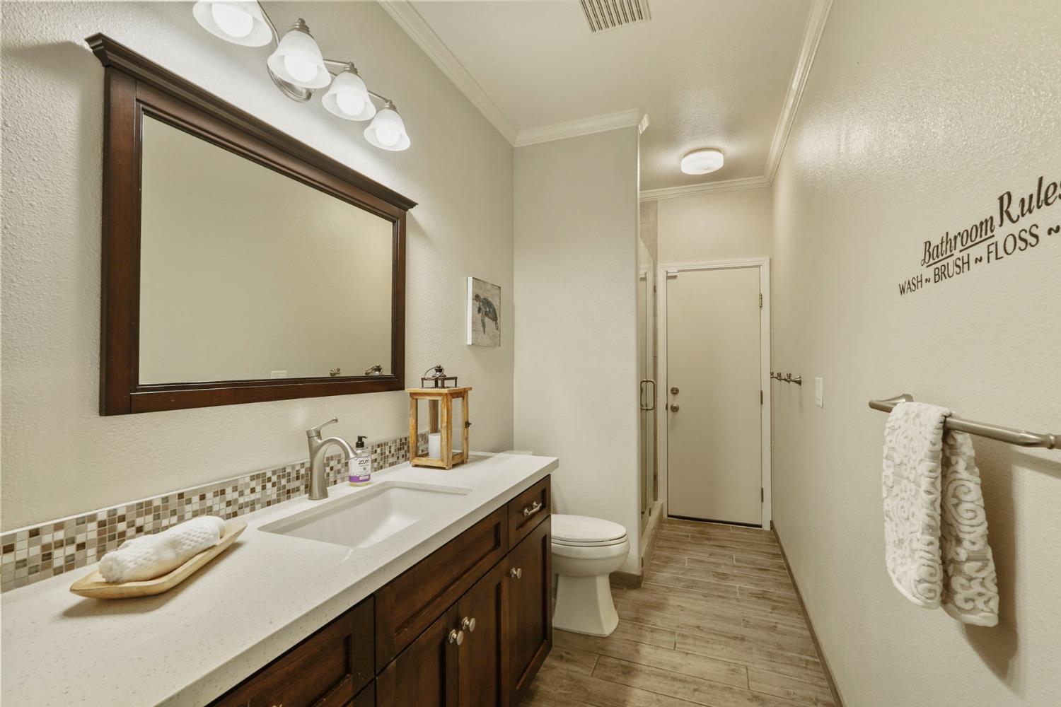 18432 Ironstone Street Woodbridge, CA 95258 - Photo 25 of 50 Full bath downstairs with stall shower and door to backyard.