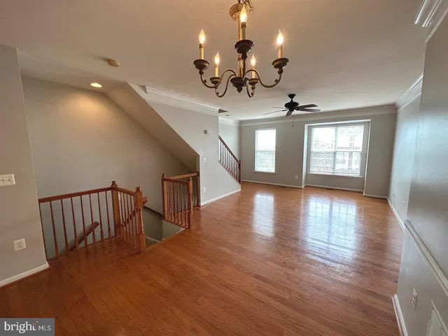 a view of a livingroom with hardwood floor and a ceiling fan