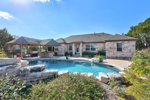 a front view of a house with swimming pool having outdoor seating