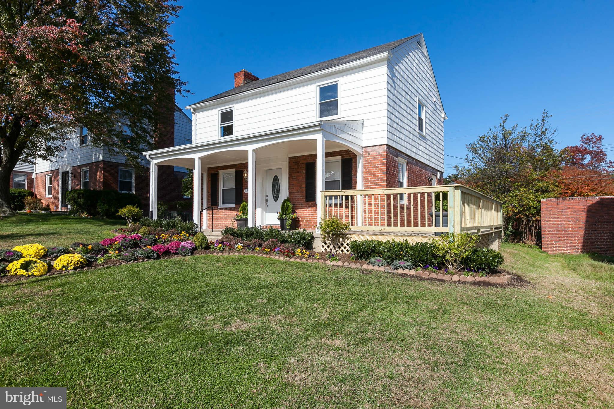 1316 East 35th Street Baltimore, MD 21218 - Photo 1 of 30 a front view of a house with a yard and potted plants