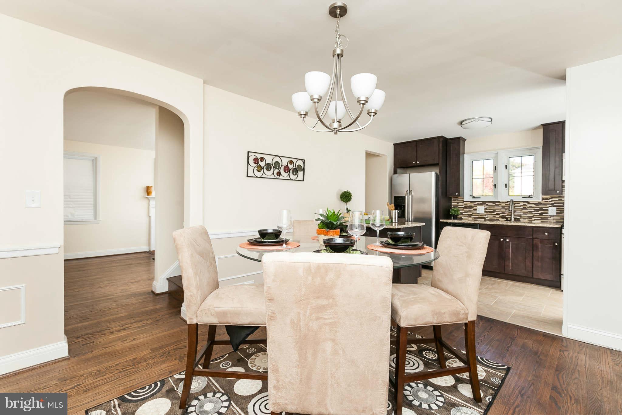 1316 East 35th Street Baltimore, MD 21218 - Photo 11 of 30 a view of a dining room with furniture wooden floor and chandelier
