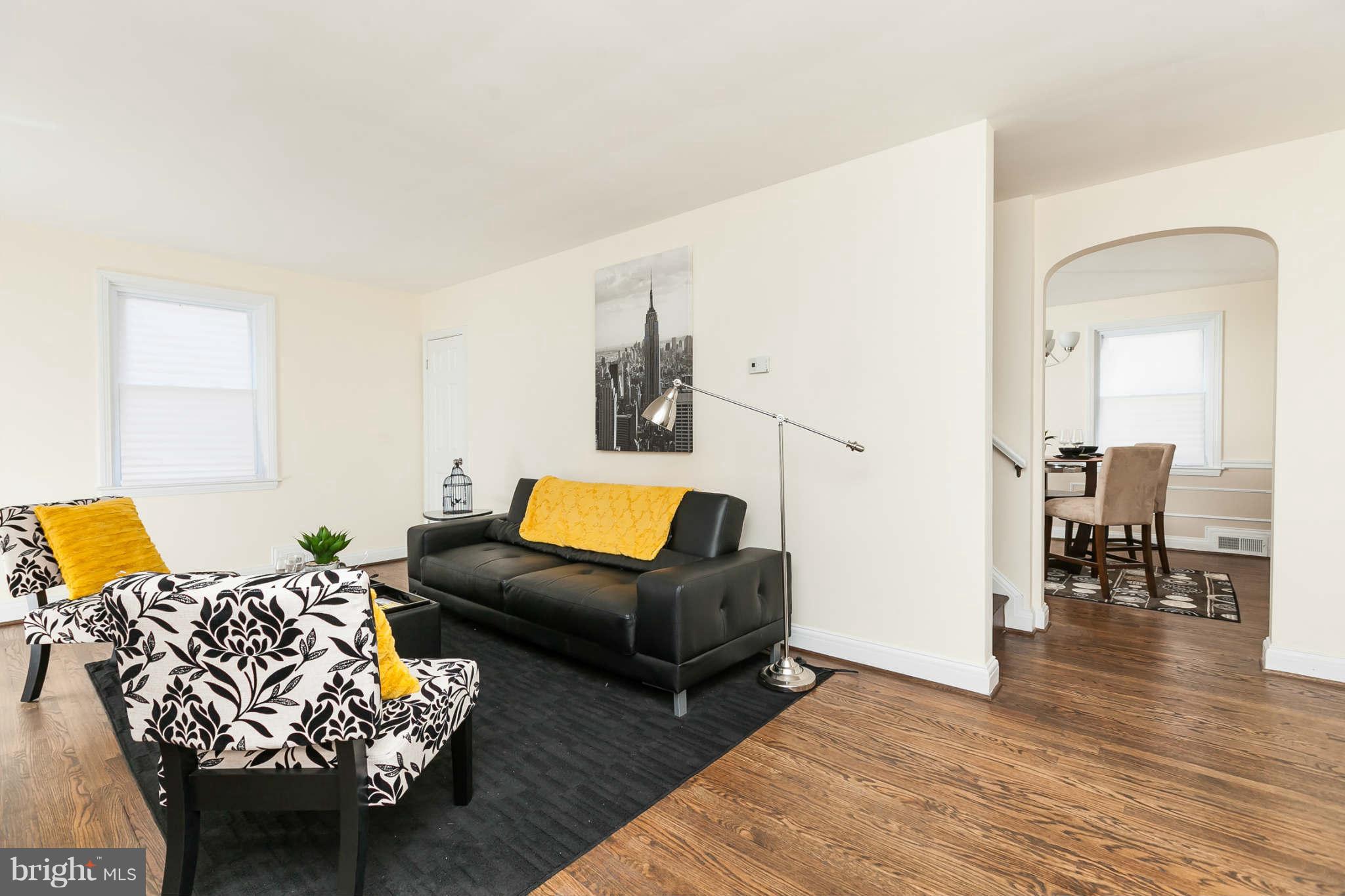 1316 East 35th Street Baltimore, MD 21218 - Photo 13 of 30 a living room with furniture and wooden floor