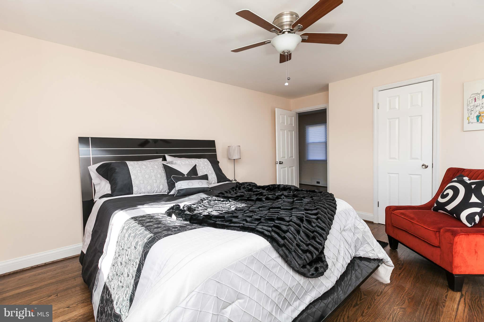 1316 East 35th Street Baltimore, MD 21218 - Photo 16 of 30 a bedroom with a bed and wooden floor