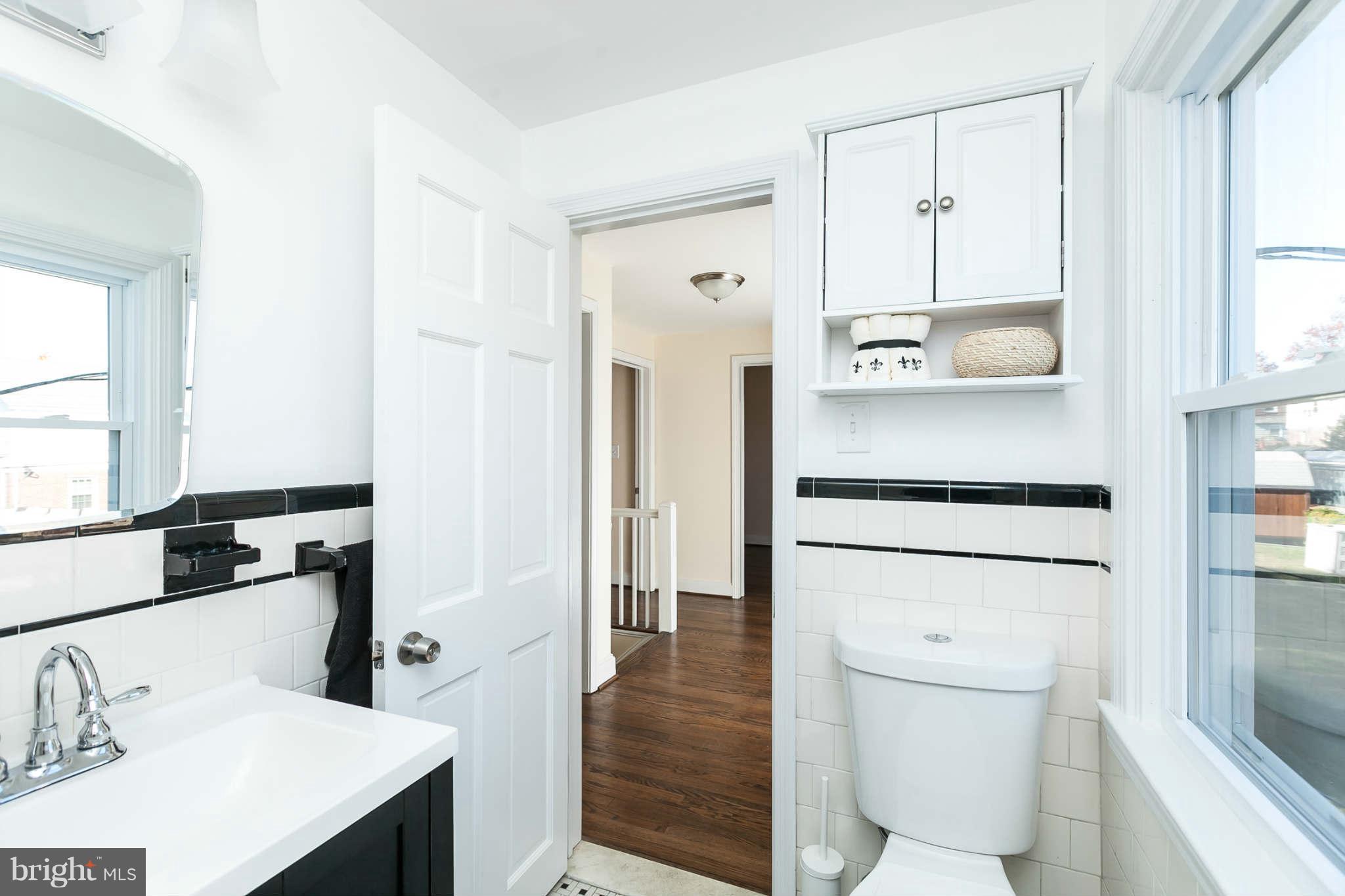 1316 East 35th Street Baltimore, MD 21218 - Photo 22 of 30 a bathroom with a sink a toilet and shower