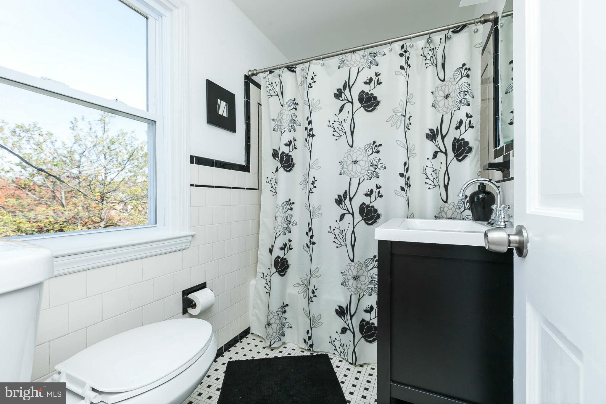 1316 East 35th Street Baltimore, MD 21218 - Photo 23 of 30 a bathroom with a toilet and a shower curtain