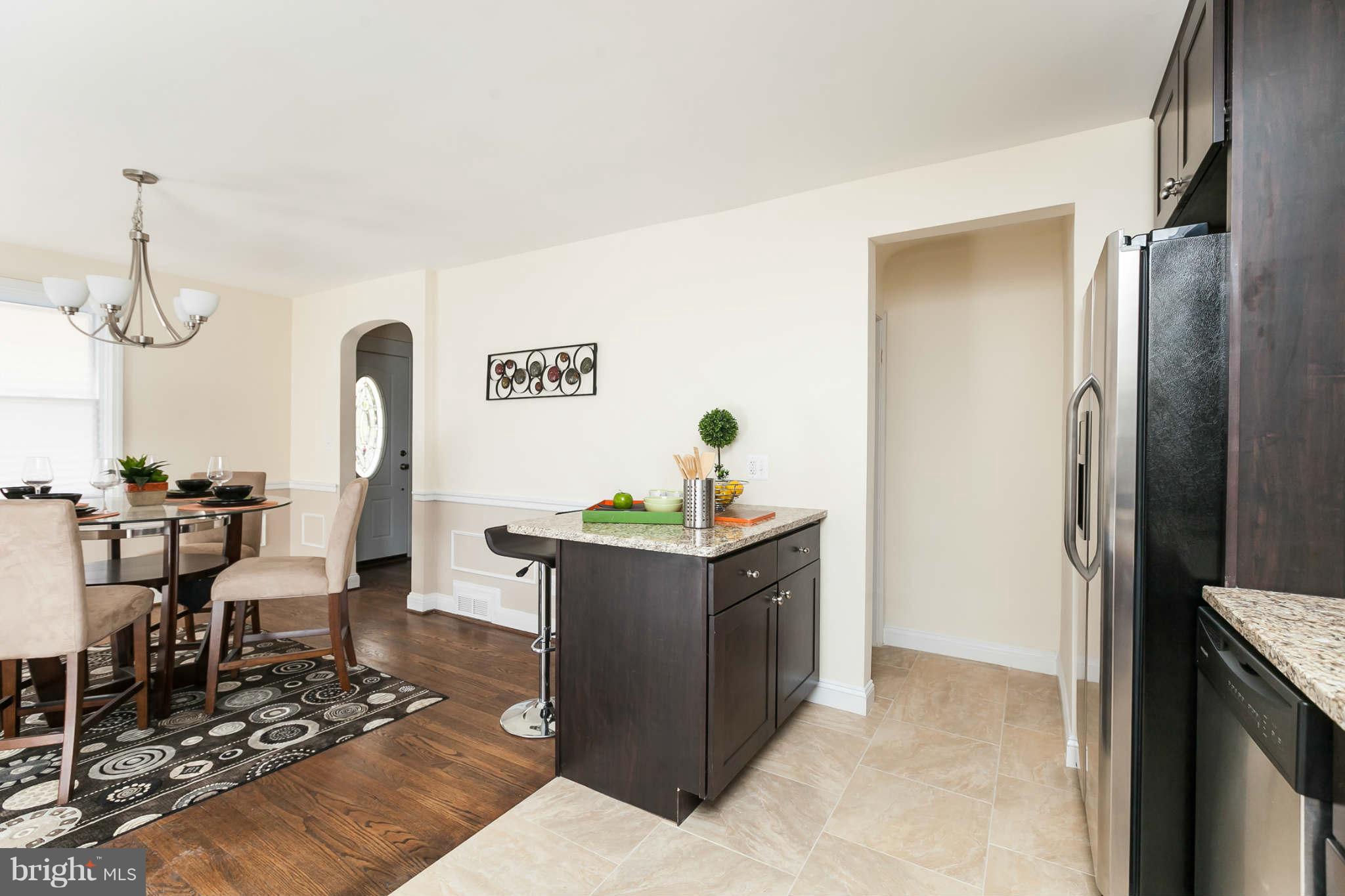 1316 East 35th Street Baltimore, MD 21218 - Photo 9 of 30 a room with table chairs and wooden floor